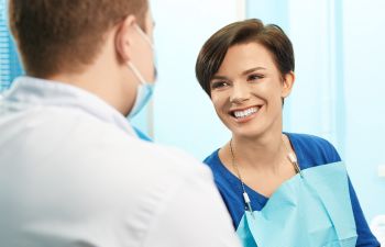a dentist and a satisfied female patient
